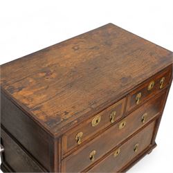 Early 18th century oak chest, rectangular top over two short and two long drawers with yew wood bands, shaped handles and escutcheons with drop handles, on stile supports 