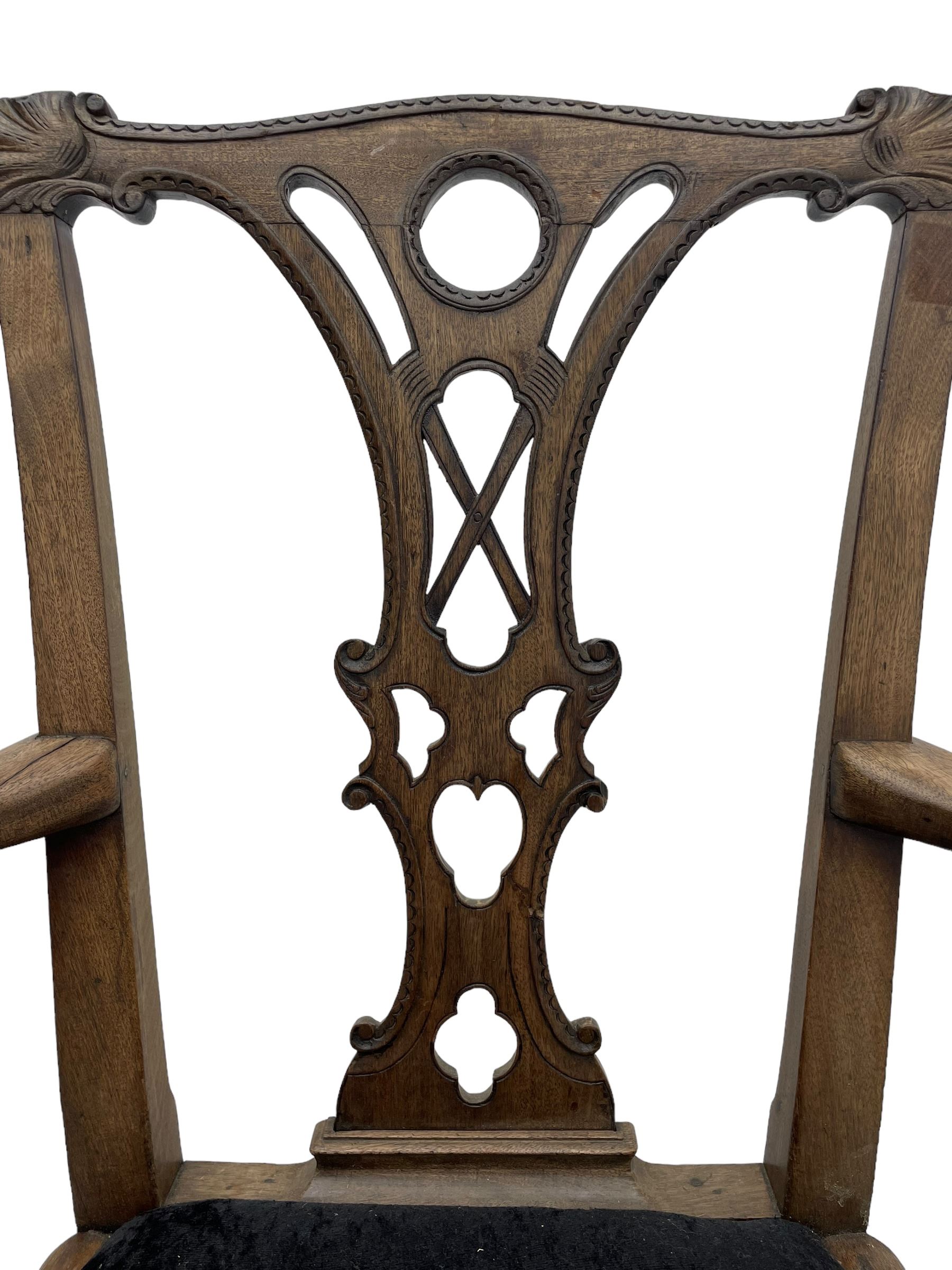 Unusual 18th century mahogany elbow chair, the shaped cresting rail with projecting shell carved ears, pierced and scroll carved splat over drop-in upholstered seat, shaped arms with ball and claw carved terminals, the seat rails carved with shell cartouches, on foliate carved cabriole supports with ball and claw feet 