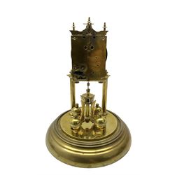 Continental- early-20th century torsion clock under a glass dome, movement raised on two pillars on a circular brass base, with an enamel dial, Roman numerals and spade hands, oscillating four ball circular pendulum. Torsion spring intact.