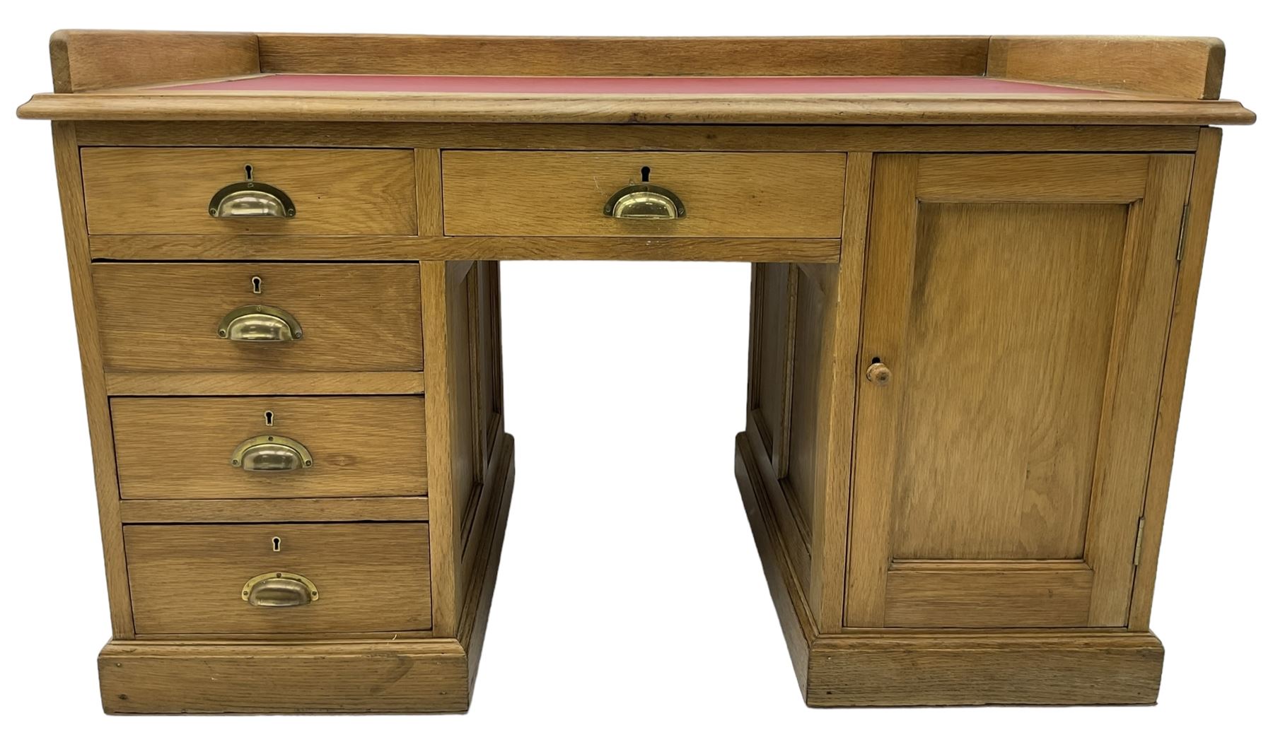 20th century oak desk, moulded rectangular top with raised back and inset leather writing surface, fitted with five drawers and single panelled cupboard, on moulded plinth base