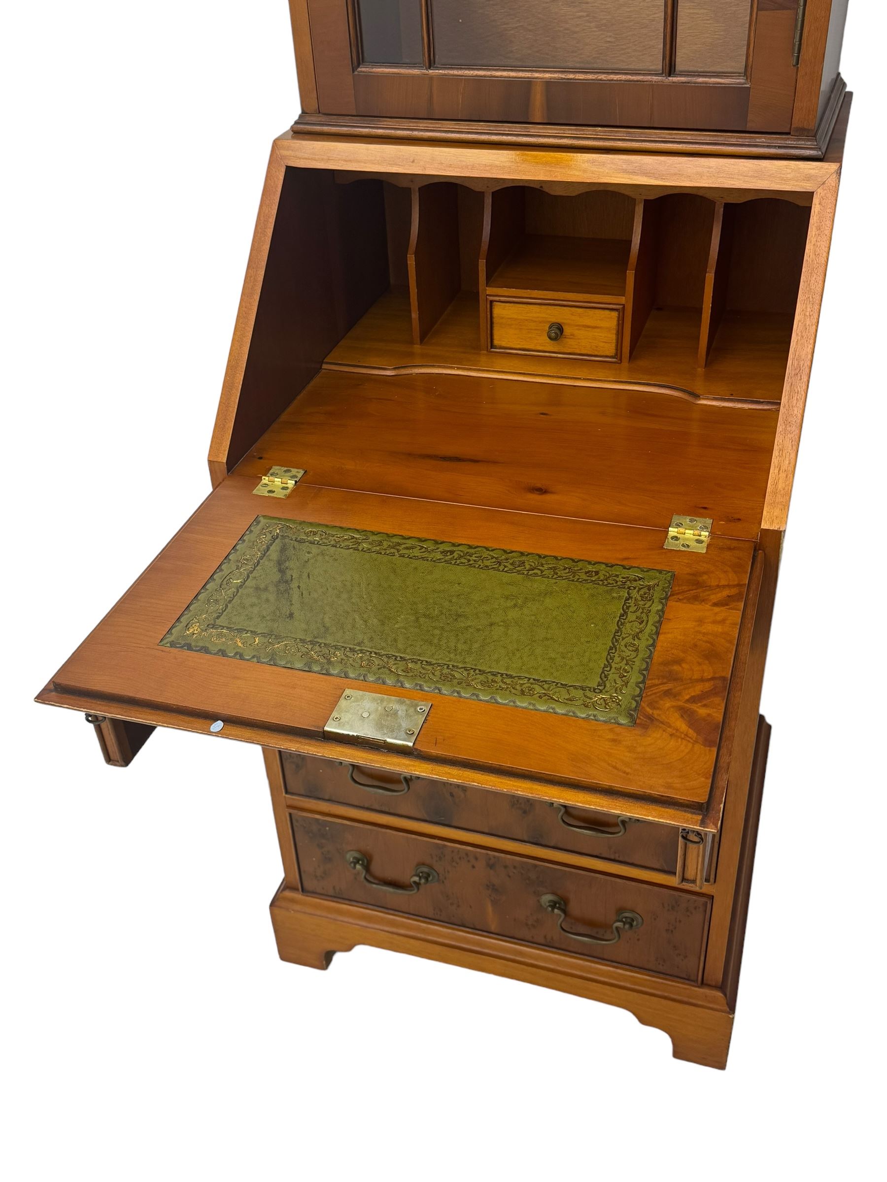 Mid-to-late 20th century yew wood bureau bookcase, raised bookcase enclosed by glazed door, the fall front revealing fitted interior, four graduating cock-beaded drawers below, on bracket feet