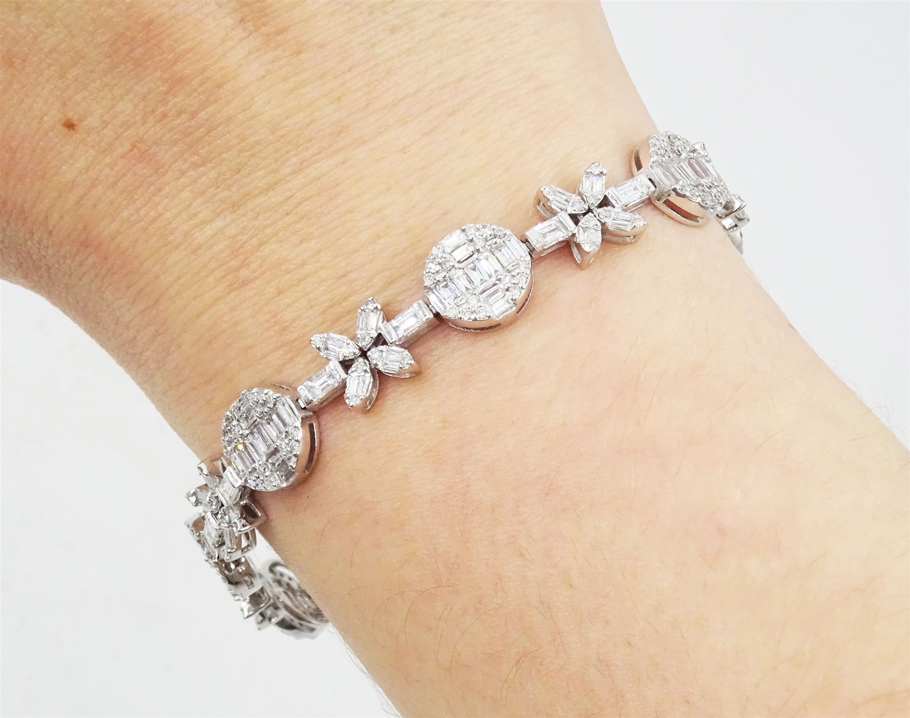 18ct white gold baguette and round brilliant cut diamond flower and circular link bracelet, stamped 750, total diamond weight approx 3.70 carat