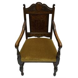 Late 19th to early 20th century oak elbow chair, the shaped cresting rail carved with scrolls and foliage, panelled back inlaid with parquetry work and central rampant lion within shield, upholstered seat, on turned supports joined by H stretchers