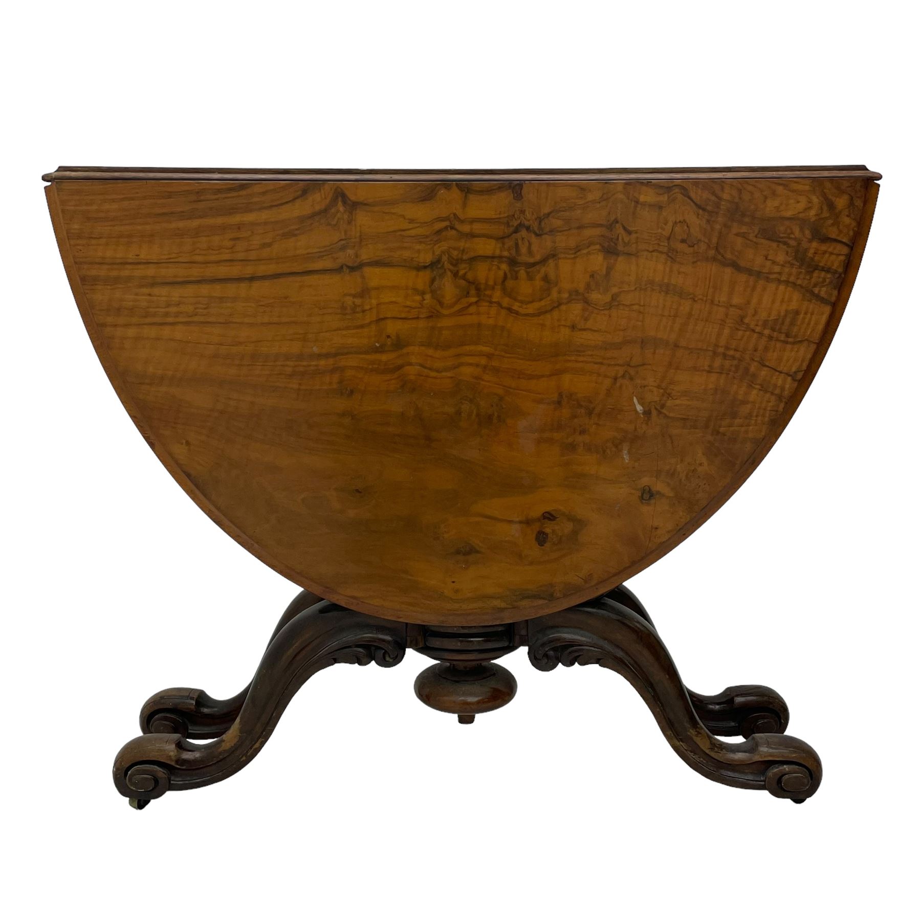 Unusual Victorian figured walnut drop-leaf Sutherland table, moulded drop-leaf oval top, central turned baluster column with quadruple moulded S-scroll supports carved with acanthus leaves, four out-splayed supports with scroll carved terminals, double gate-leg action base, on castors