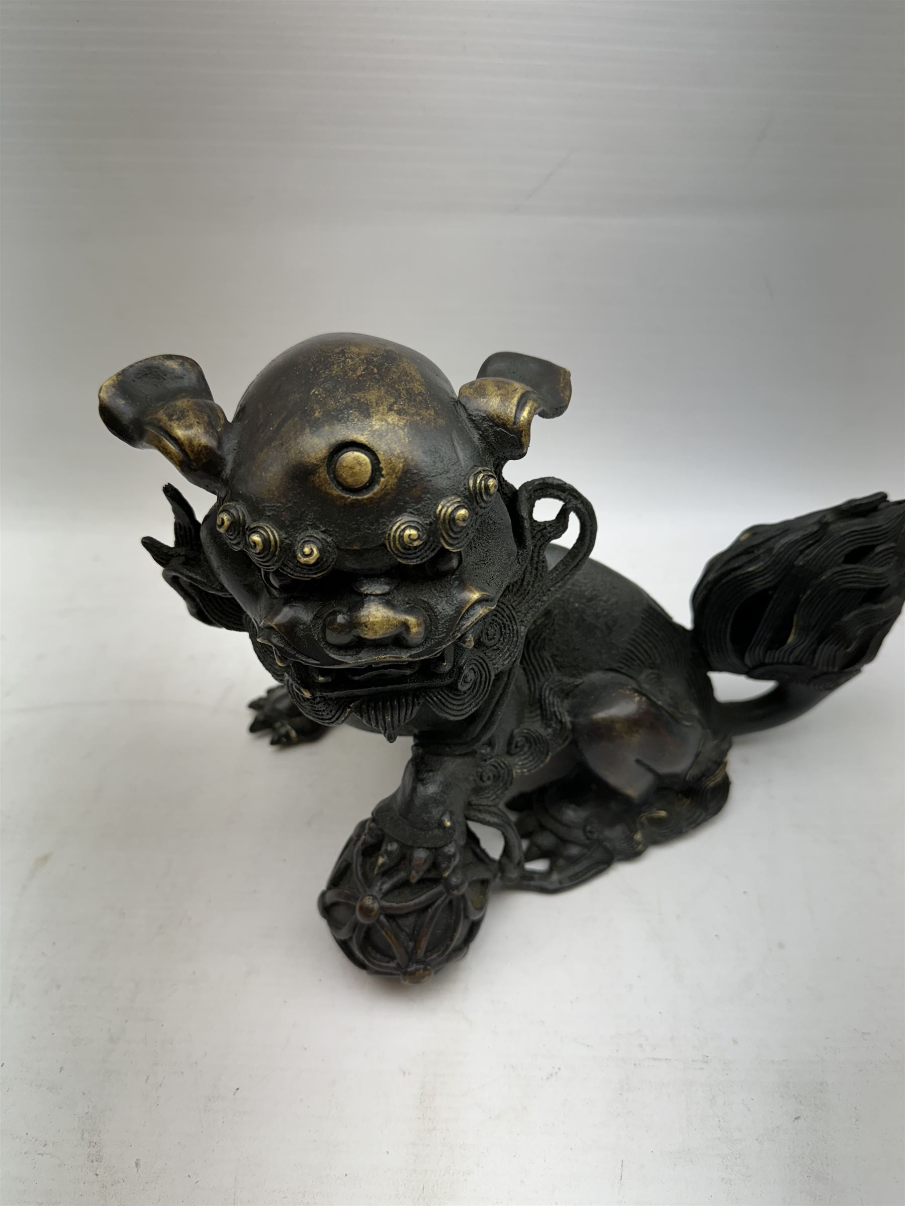 Bronze dog of foo, modelled with one paw placed upon ball, H18cm