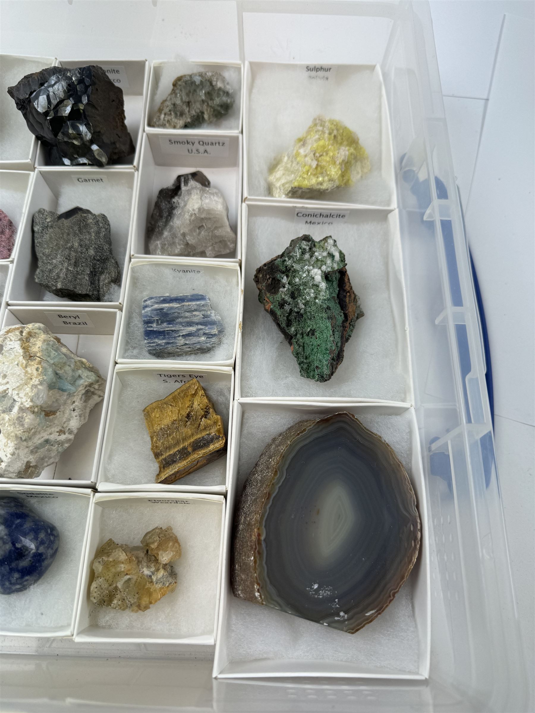 Collection of twenty-three mineral specimens, including orange calcite, realgar, conichalcite etc 
