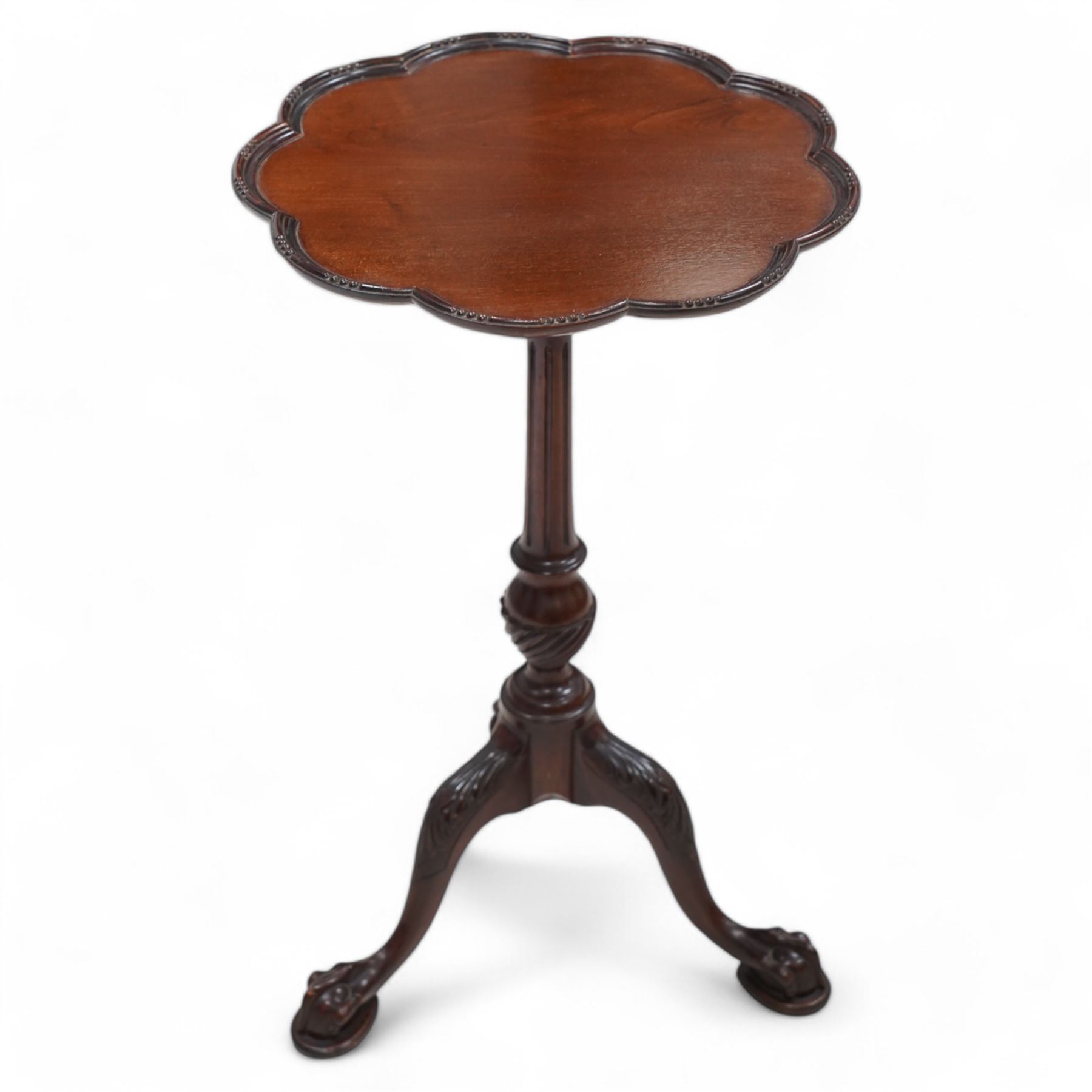 Georgian design mahogany wine table, circular dished top with moulded scalloped edge, raised on a fluted pedestal with spiral reeded decoration, tripod base with splayed supports carved with acanthus leaves, terminating to ball and claw feet 