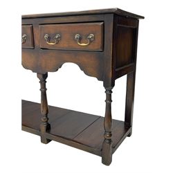 Georgian design oak dresser base, rectangular three plank top over three drawers and shaped apron, moulded drawer fronts with brass swan neck handles and circular plates, turned supports on panelled pot board base