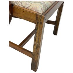 George III walnut elbow chair, shaped cresting rail over shaped pierced splat, the shaped arms with scroll carved terminals, upholstered drop in seat, on square chamfered supports united by plain stretchers 