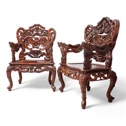 Pair of Japanese carved hardwood throne chairs, pierced and dragon carved cresting over pierced back panel carved with bat, extending dragon carved arms over panelled seat, the seat rails pierced and carved with trailing branches and foliate motifs, on cabriole supports 