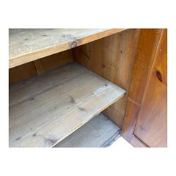 Large 19th century pine cupboard, rectangular top over two panelled later doors, enclosing four open shelves, on plinth base