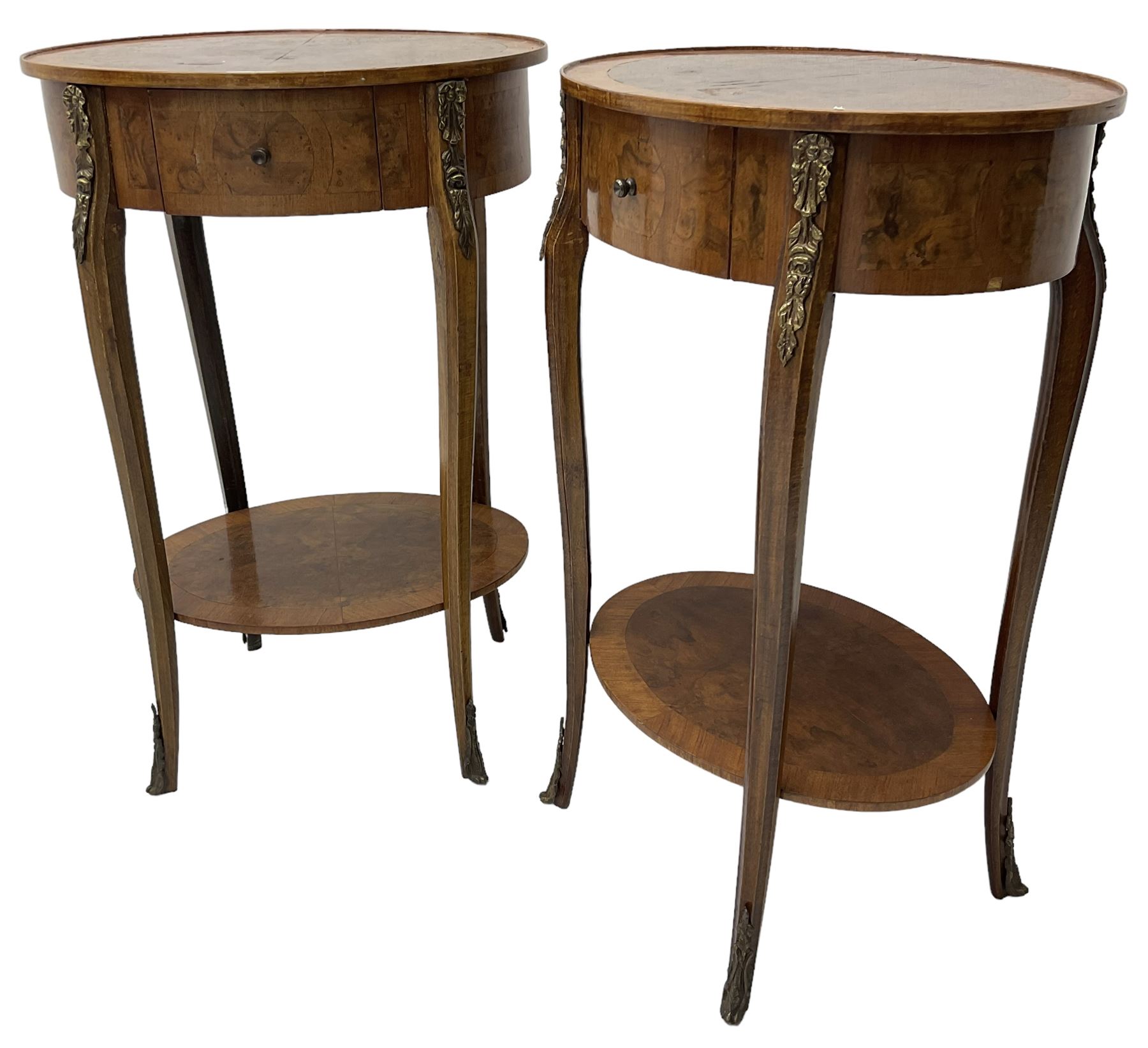 Pair of early 20th century French walnut bedside stands, oval bookmatched and cross-banded top fitted with single drawer, raised on cabriole supports united by undertier, decorated with floral gilt metal mounts