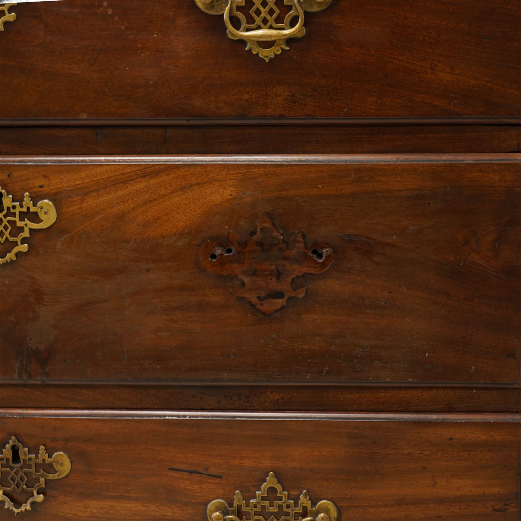 George III mahogany canted chest-on-chest, moulded cornice over three short and six long moulded drawers, shaped and pierced handle plates with swan neck handles, fluted upright canted corners, on bracket feet 