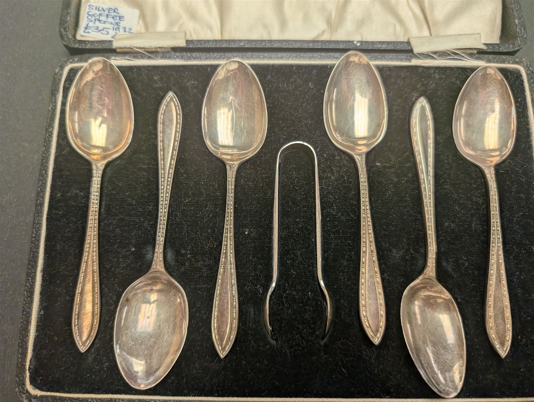 Cased set of six silver coffee spoons and a pair of sugar tongs, hallmarked 