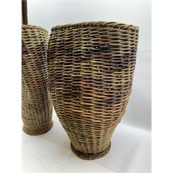 Two rattan baskets, of circular abstract form, together with two crook walking stick, basket H62cm 