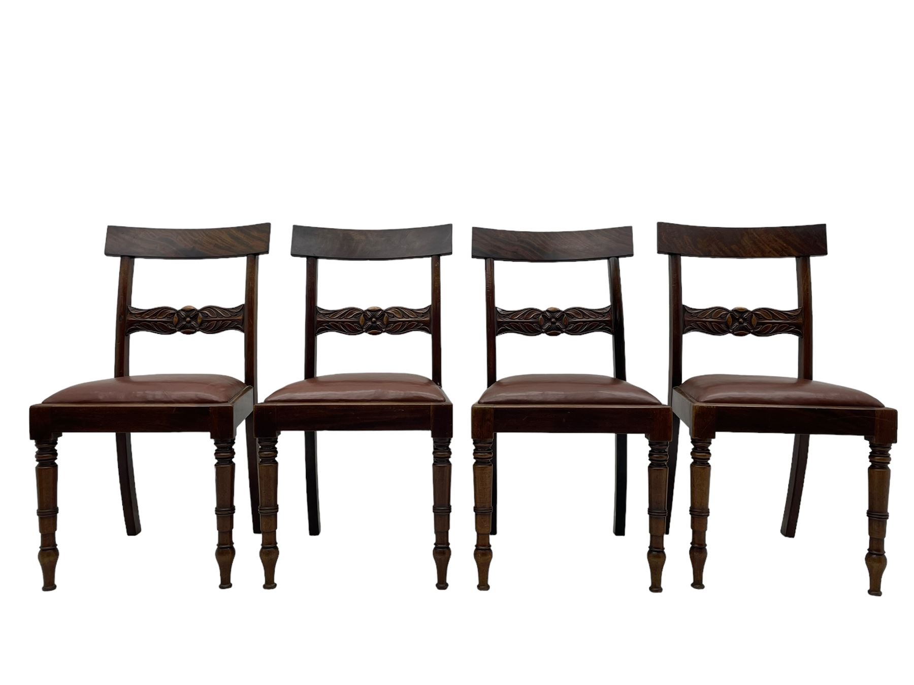 Set of six (4+2) early 19th century mahogany dining chairs, figured bar back over rose and curled leaf carved middle rail, drop-in seats upholstered in brown fabric, on turned front supports 