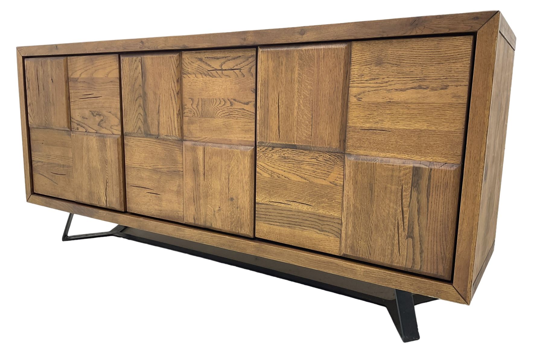 Samba 'Camden' oak sideboard, rectangular top over three block panelled cupboard doors, raised on angled black metal supports connected with stretcher