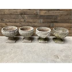 Pair of circular cast stone circular planters, and a similar pair decorated with swags (4)