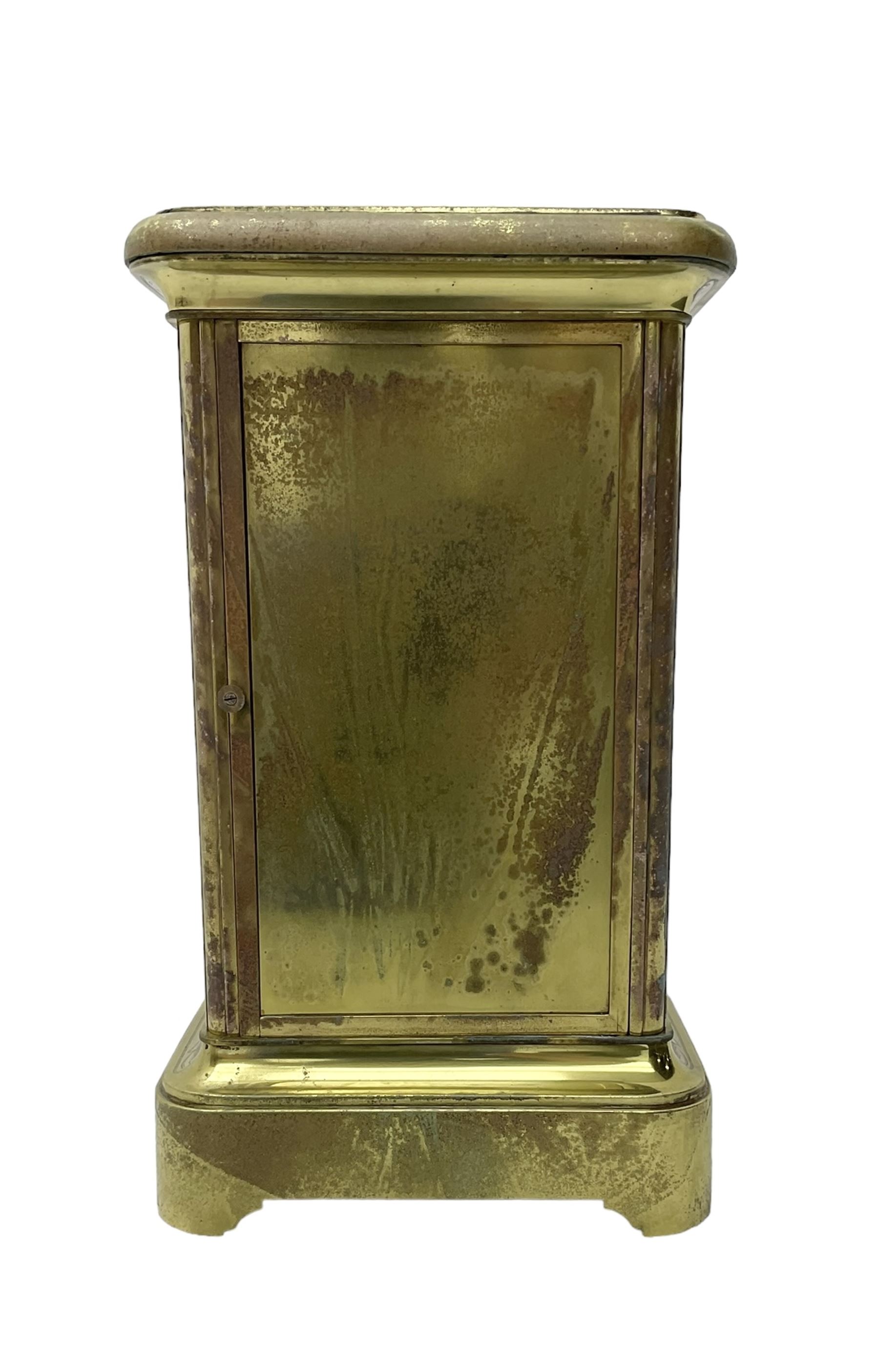 French - late 19th century 8-day mantle clock in an engraved brass corniche case with three rectangular porcelain panels decorated in the romantic Sevres style, dial with brass hands, cartouche Roman numerals and a depiction of cupid to the dial centre, rack striking movement sounding the hours and half hours on a bell. With pendulum.