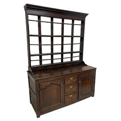 18th century oak dresser, projecting cornice over three heights plate rack with three small drawers, rectangular ovolo-moulded top over three central drawers and two flanking cupboards, enclosed by fielded panelled doors, on stile supports 