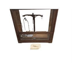 Set of Reynolds & Branson balance scales, in glazed wooden case, together with a fossilise...