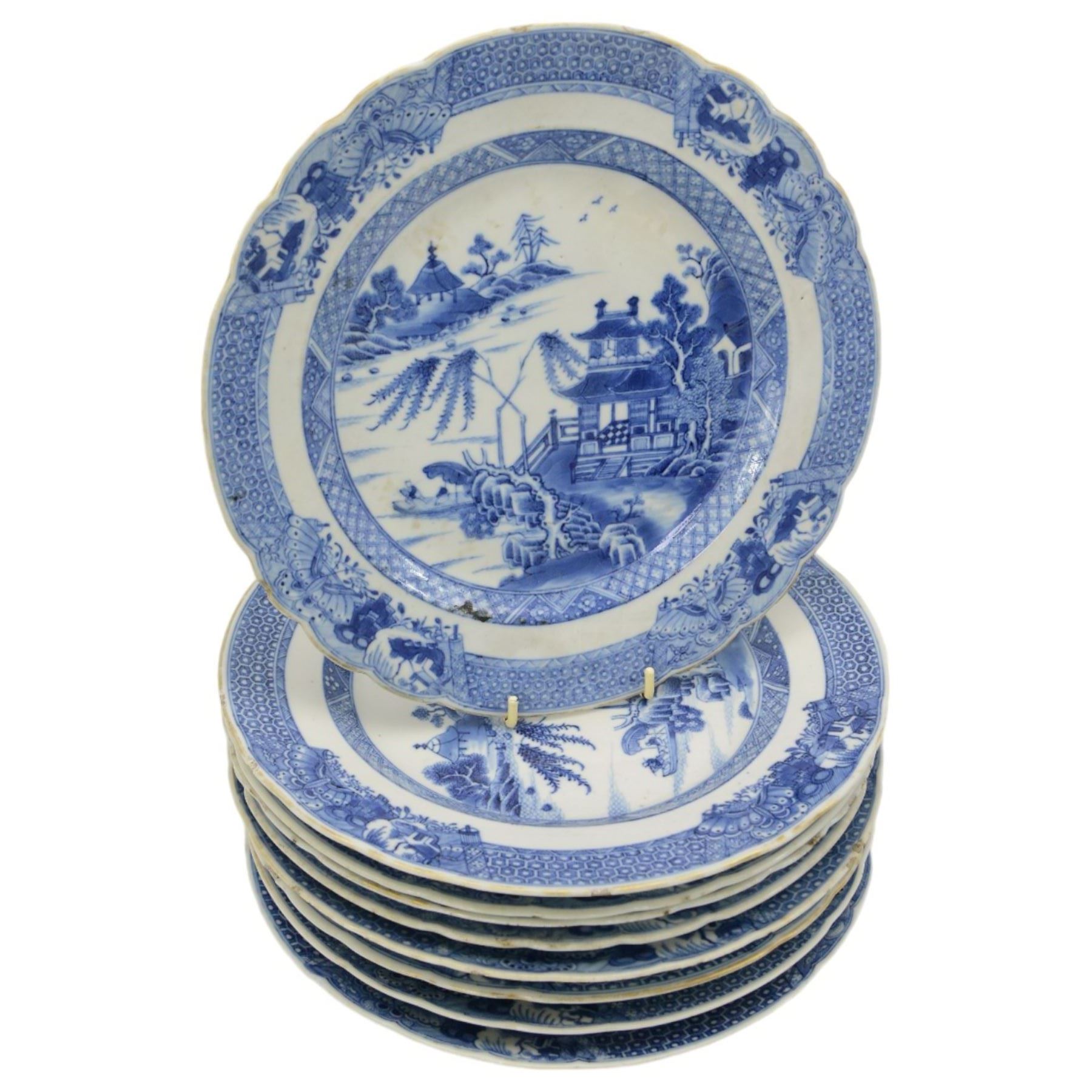 18th century Chinese Export blue and white part dinner service, comprising four soup bowls, four tea plates, sauceboat and stand, five dinner plates, D24cm, five bowls and a smaller plate, each decorated with pagodas and figures in a landscape, within foliate and cell borders, together with three matching 18th century Chinese Export rectangular platters, max L29cm (24)