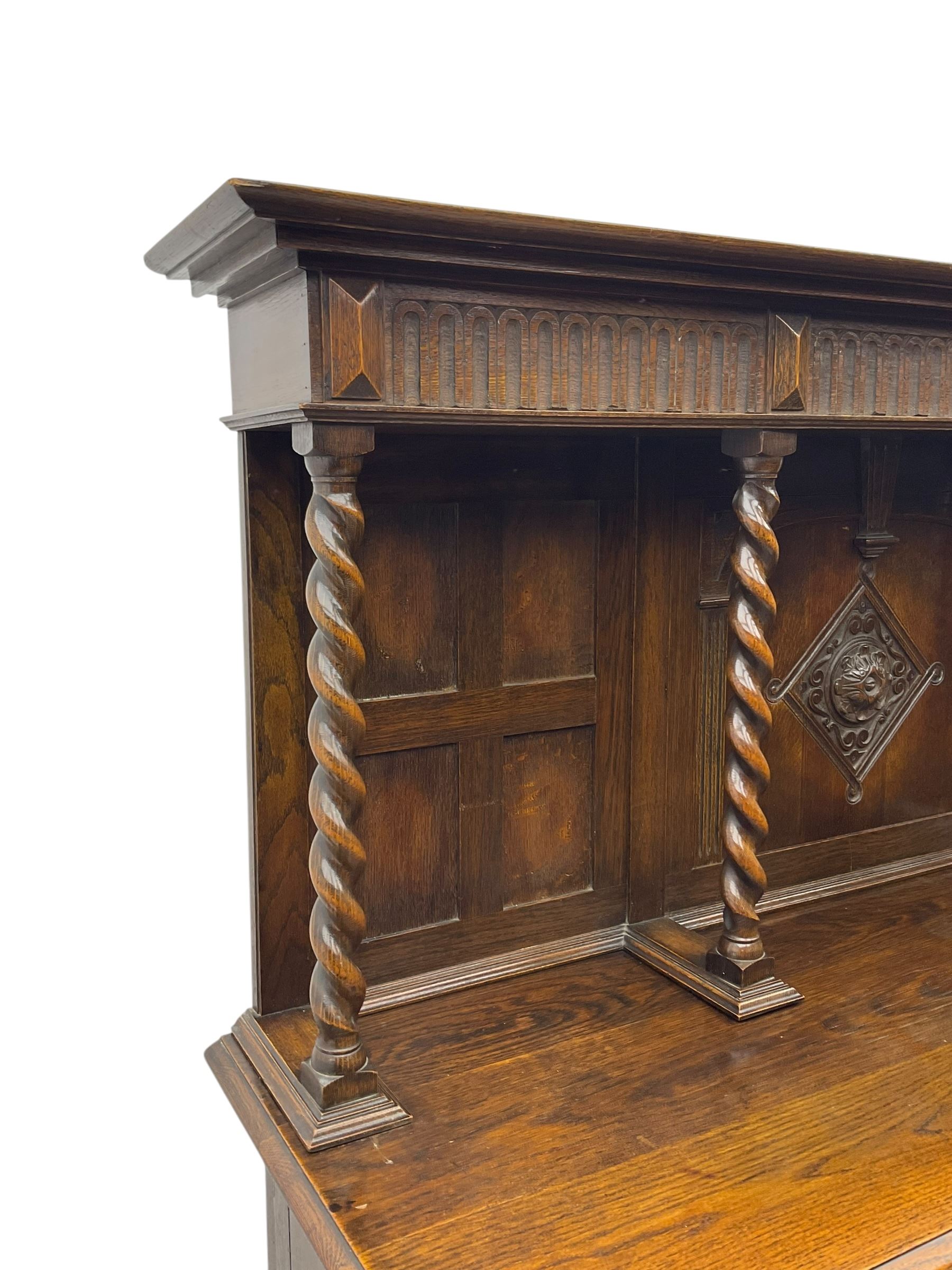 Jacobean Revival oak dresser, projecting moulded cornice over arcade carved frieze and panelled back, on spiral turned supports, moulded rectangular top over two cupboards and two drawers, on spiral turned supports united by moulded stretchers 