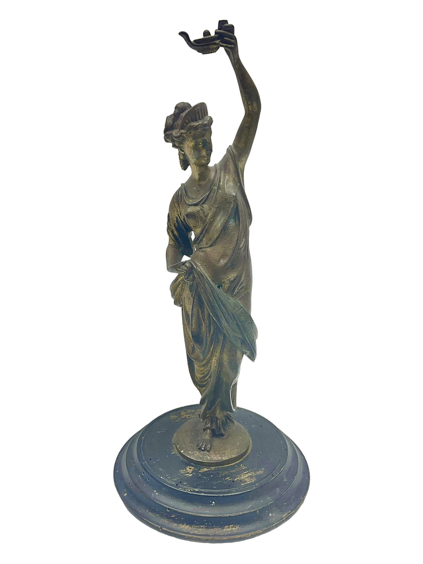 Gilt bronze figure of a lady in neo-classical dress, on a circular wooden plinth, H26cm