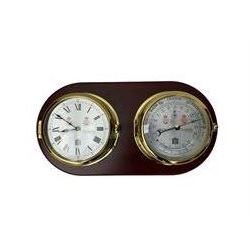 Sewell's - 20th century matching compendium aneroid barometer and quartz clock on a mahogany board,