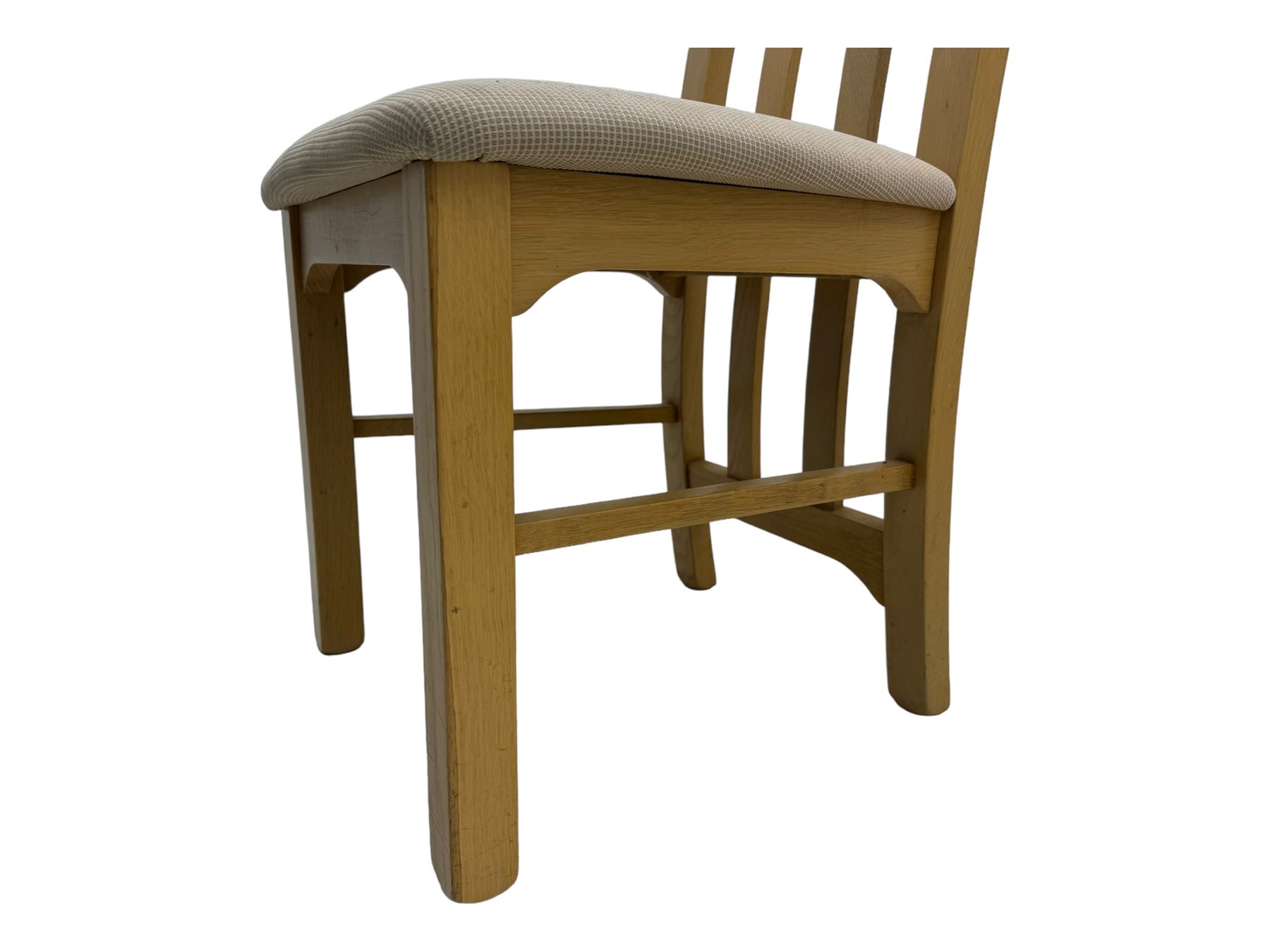 Contemporary set of four oak dining chairs, tall slatted curved backs with square cutouts to the top, upholstered seats in light fabric, on square front supports