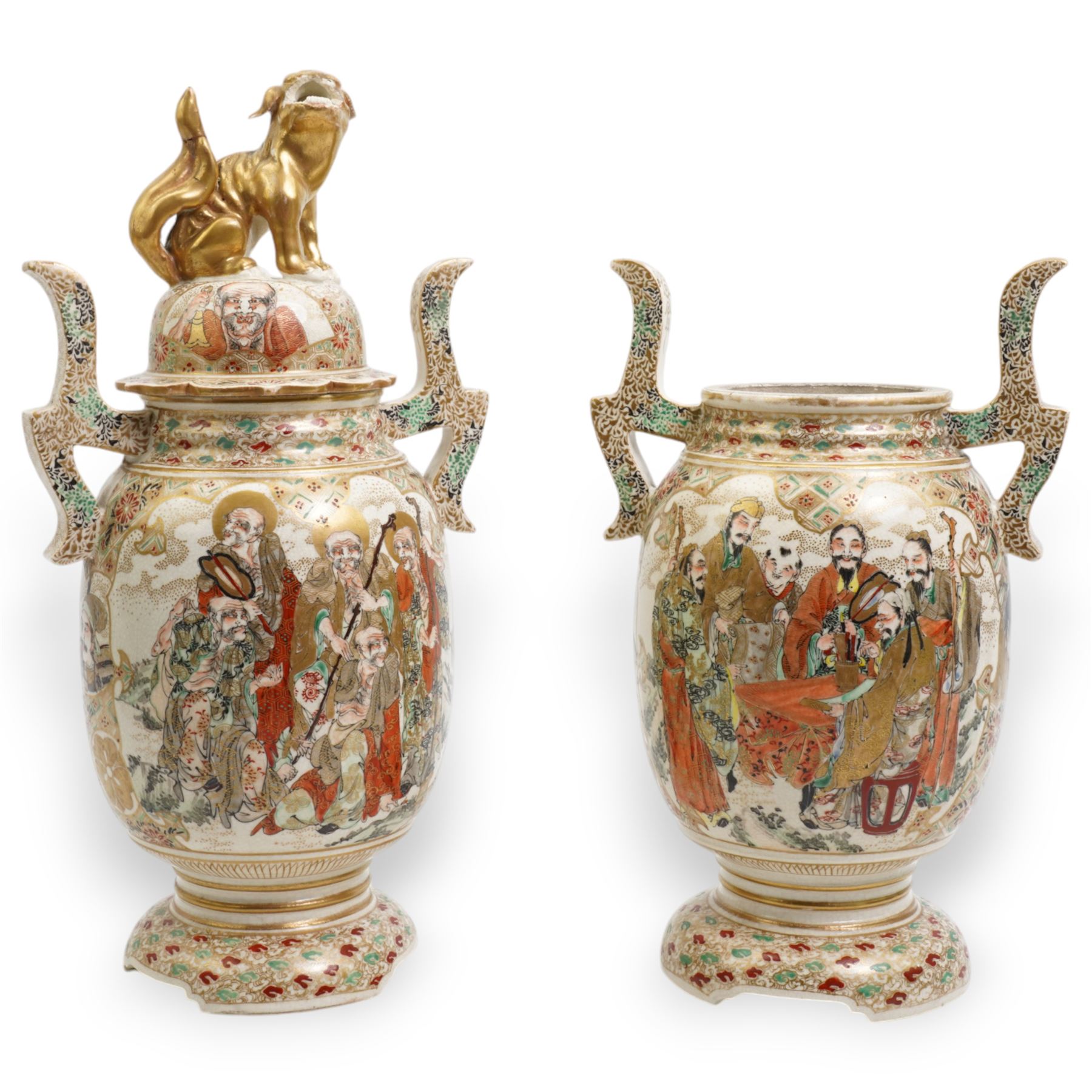 Pair of early 20th century Japanese Satsuma vases, of twin-handled form, one with temple lion finial cover, painted with immortals against a dense cloud and geometric patterned ground, H33cm