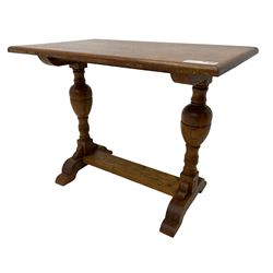 20th century oak occasional table, rectangular top on turned twin pillar supports, carved with squirrel motif, on shaped sledge feet united by stretcher 