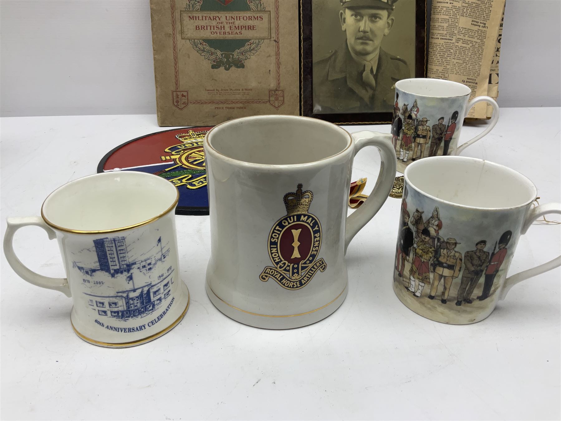 Collection on military items, including John Player & Sons Military Uniforms of the British Overseas, medal ribbon, ceramics and a reproduction metal plaque 