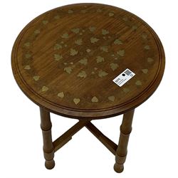 Small brass inlaid hardwood occasional table, the circular top inlaid with trailing foliate decoration, on turned folding base 