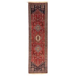 Persian Qashqai crimson ground runner, the central field decorated with three large geomet...