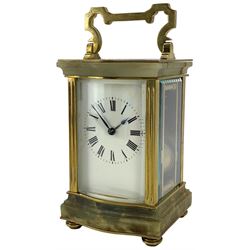 French - early 20th century two train carriage clock, in an onyx serpentine case raised on bun feet, with four bevelled panels and rectangular escapement viewing panel, white enamel dial with Roman numerals and steel spade hands, 8-day movement with a jewelled lever platform escapement and rack striking, sounding the hours and half hours on a coiled gong. With key.