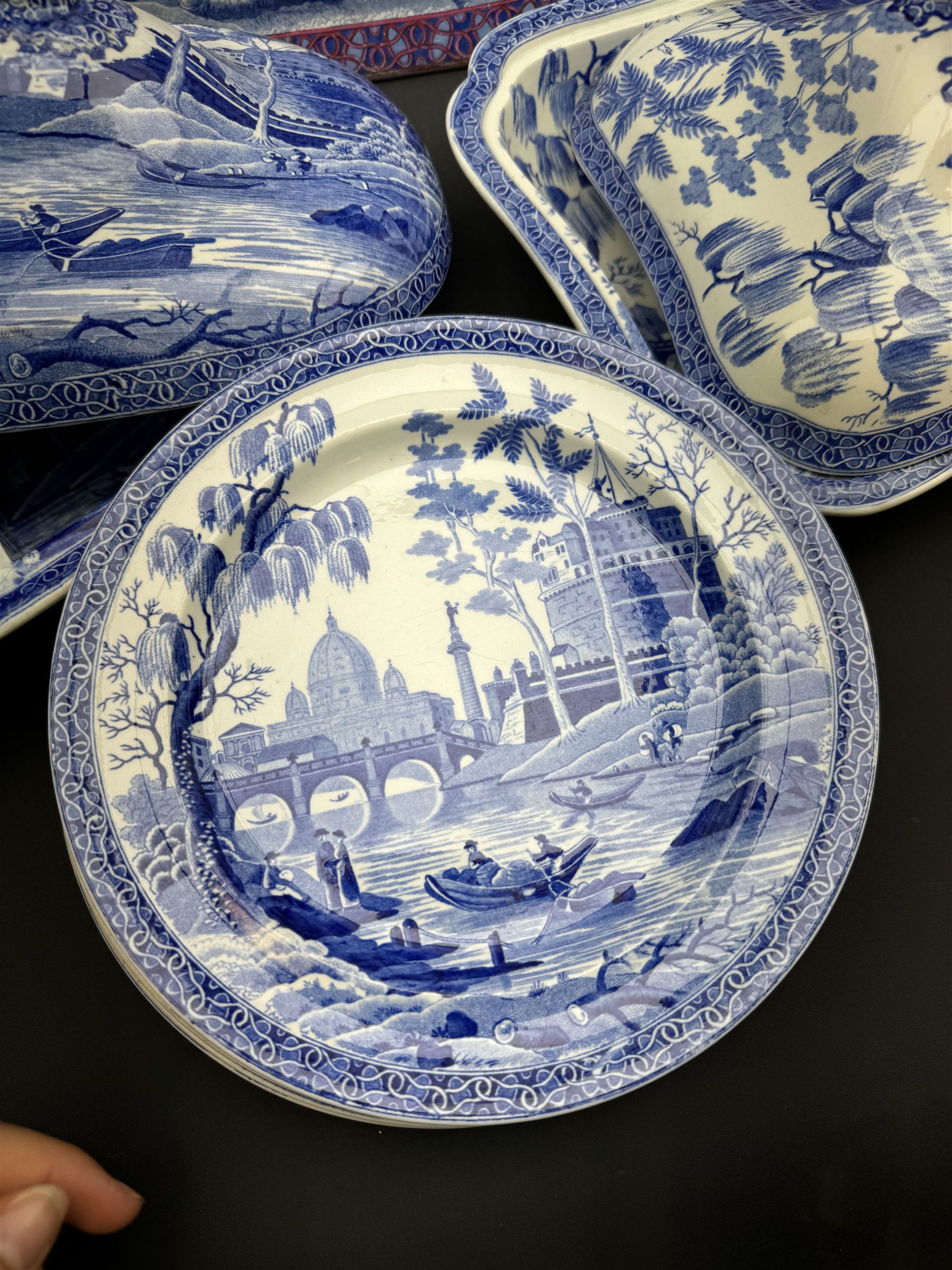 19th century Spode blue and white dinner service for six place settings, decorated in the Tiber pattern, comprising six dinner plates, six dessert plates, meat drainer with red clobbered edge, oval serving dish with twin compartmented interior and matched cover, square serving dish with cover, and two oval platters