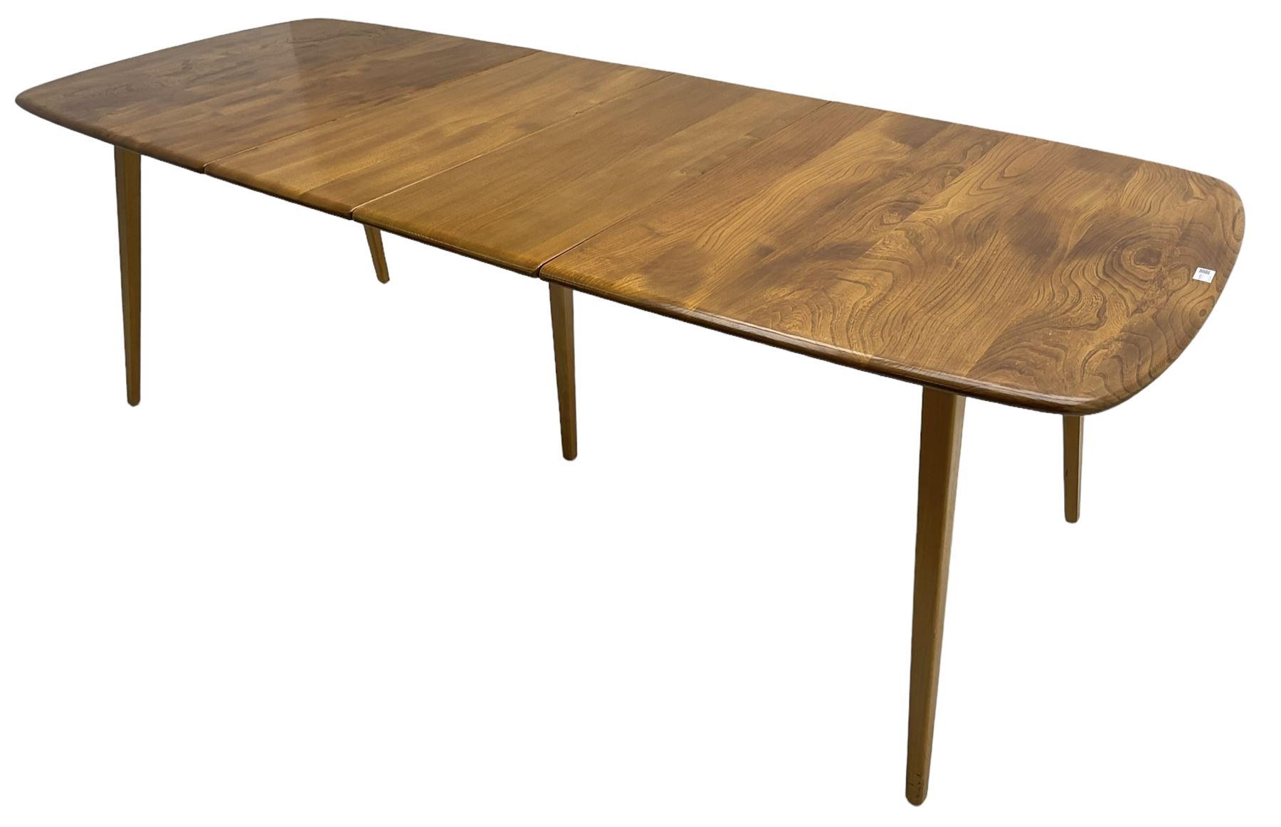 Ercol - light elm and beech 'Slide Leg Expanding Dining Table (444)', rectangular top with rounded corners, raised on tapered splayed supports, with two additional leaves