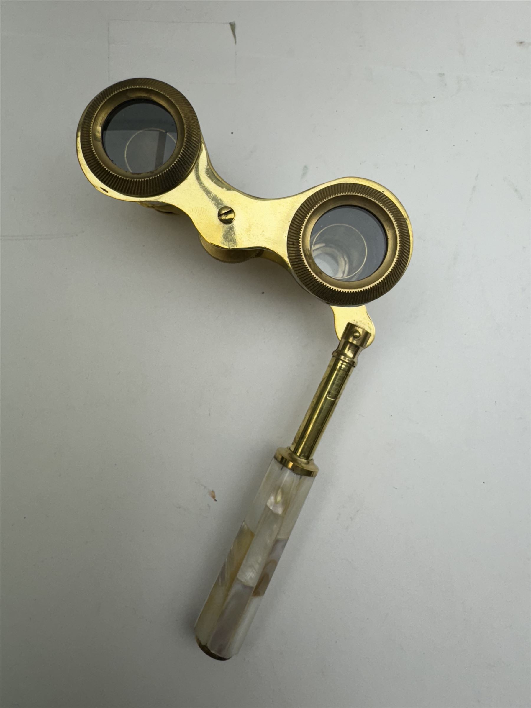 Pair of brass and mother of pearl opera glasses, together with a gilt metal pair of racing binoculars and one other pair, etc 