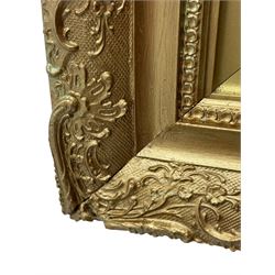 Rectangular wall mirror, in ornate gilt frame decorated with trailing leafy branches and flower heads 