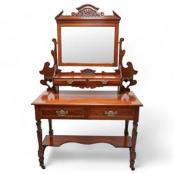 Late Victorian walnut dressing table, raised swing mirror back over two trinket drawers with brass Art Nouveau handle plates, rectangular top fitted with two further drawers, raised on square ring-turned supports united by shaped under-tier, on castors