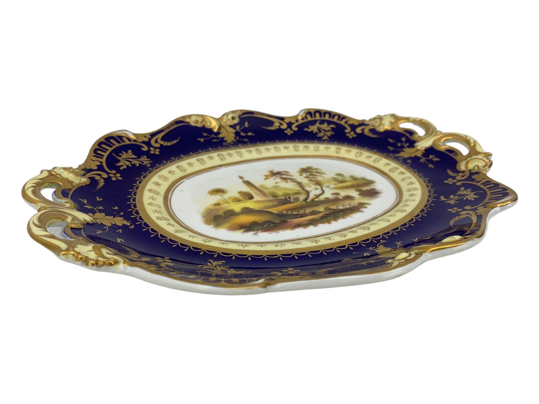 Early 19th century Ridgway twin handled oval dish, hand painted with figures in a river landscape, within a cobalt blue and moulded border, L30cm together with a similar twin handled serving dish, L28cm (2)