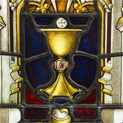 19th century leaded glass religious panel with a central chalice and various symbols 38cm x 61cm