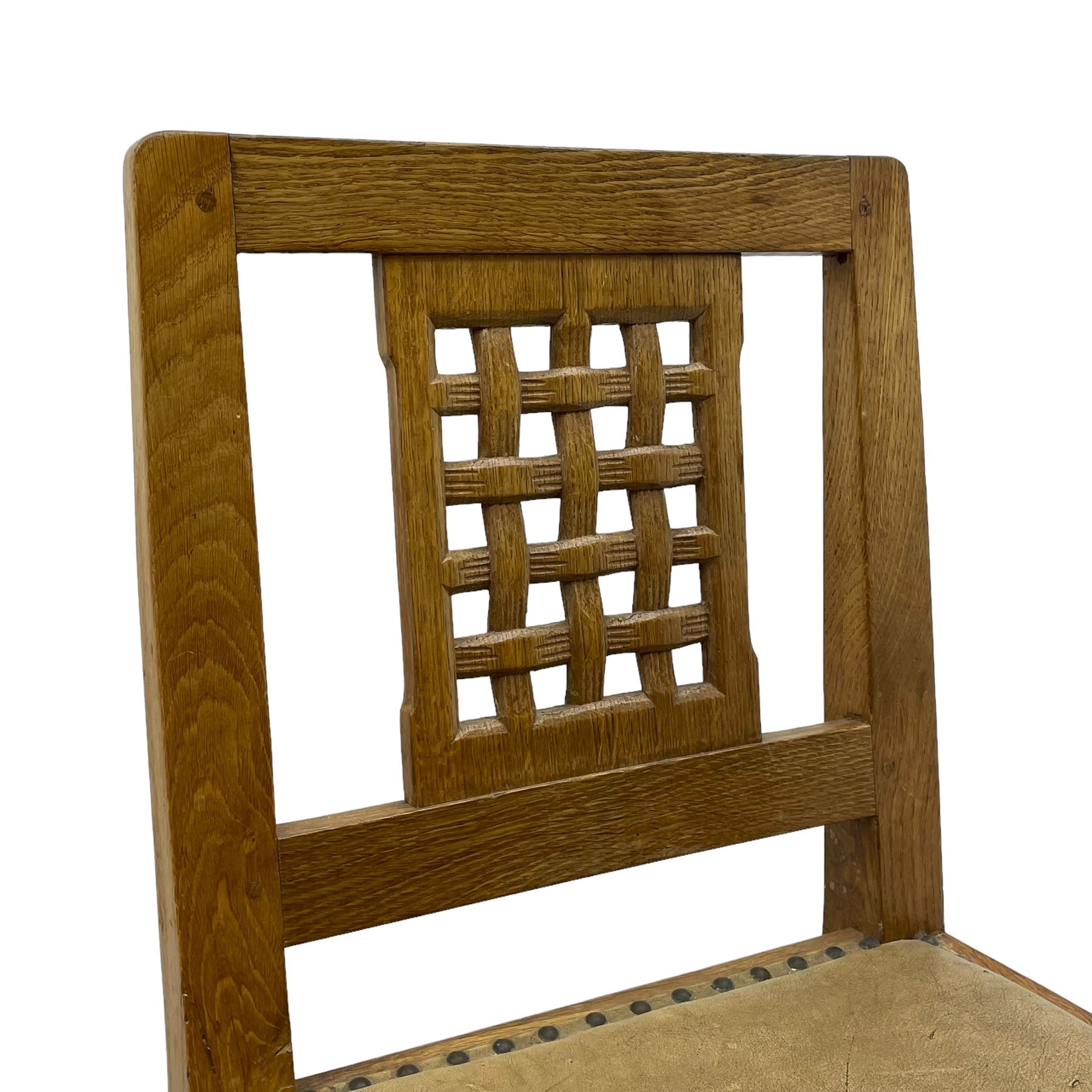 Rabbitman - set of six (5+1) oak dining chairs, pierced and carved lattice back, leather upholstered seat with stud band, on octagonal supports united by stretchers, carved with rabbit signature, by Peter Heap of Wetwang 