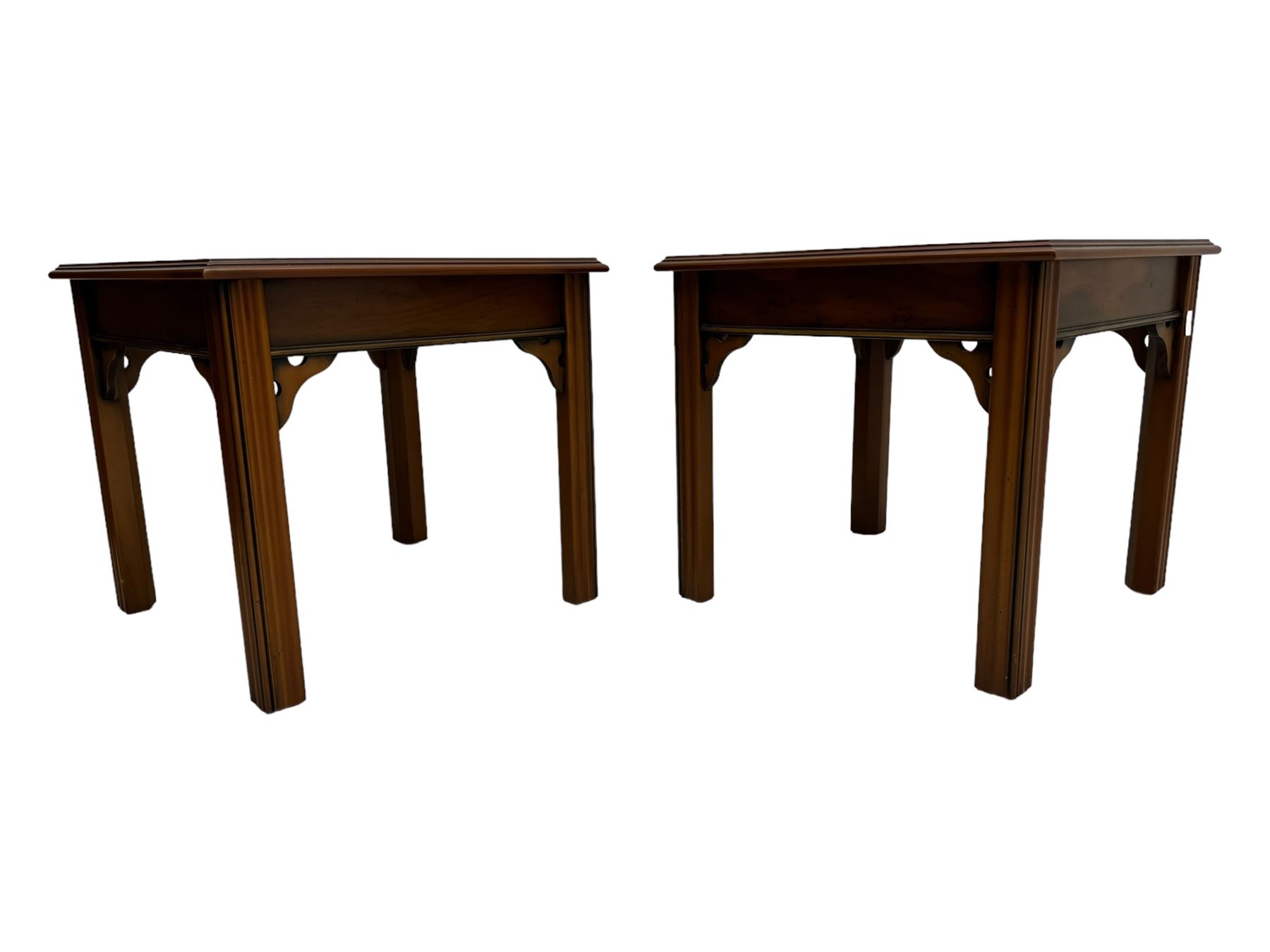 20th century pair of yew wood lamp tables, moulded square top with pierced corner brackets, on fluted straight supports 