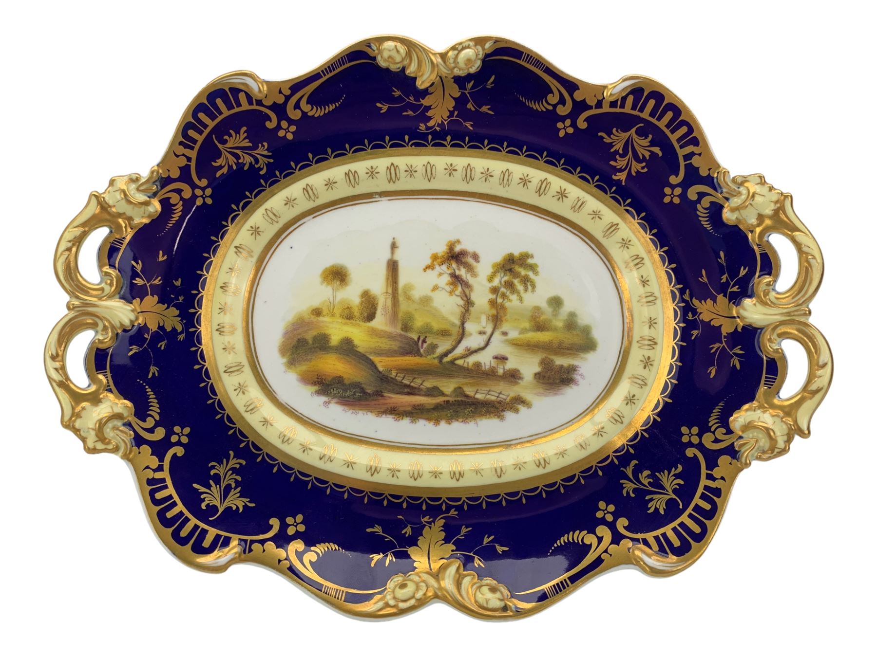 Early 19th century Ridgway twin handled oval dish, hand painted with figures in a river landscape, within a cobalt blue and moulded border, L30cm together with a similar twin handled serving dish, L28cm (2)