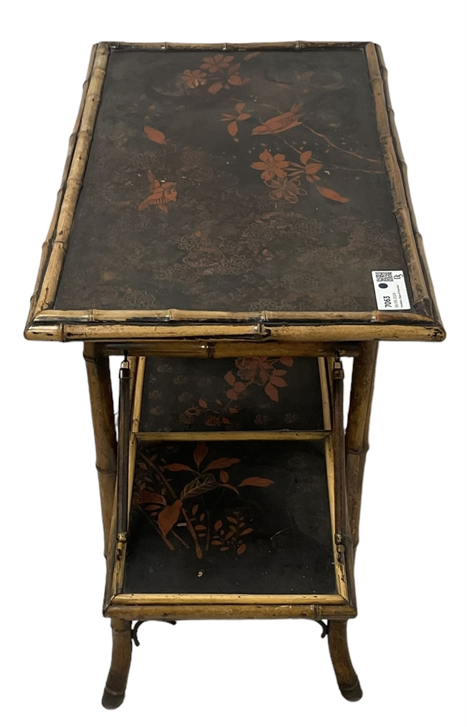 Late 19th century Aesthetic Movement lacquered and painted bamboo occasional table, rectangular top painted with Japanned traditional bird and blossom scenes, over two fold-out side leaves and undertier with pierced gallery apron