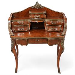 Early 20th century Louis XV design Kingwood and ormolu mounted bonheur du jour, shaped raised back fitted with five drawers and central recess, surmounted by scrolling foliate casting and pierced gallery, single frieze drawer with sliding top inset with crushed velvet, on cabriole supports mounted by mask castings with extending floral decoration, the sides and drawer fronts inlaid with parquetry panels 