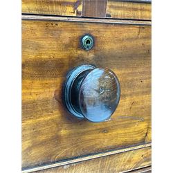 Victorian figured mahogany linen-press, projecting moulded cornice over two arch panelled doors, fitted with two short and two long cock-beaded drawers, on turned feet