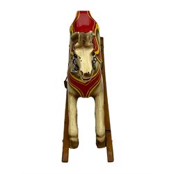 20th century rocking horse, painted body, glass eyes, metal stirrups and chain, wooden bow rocker